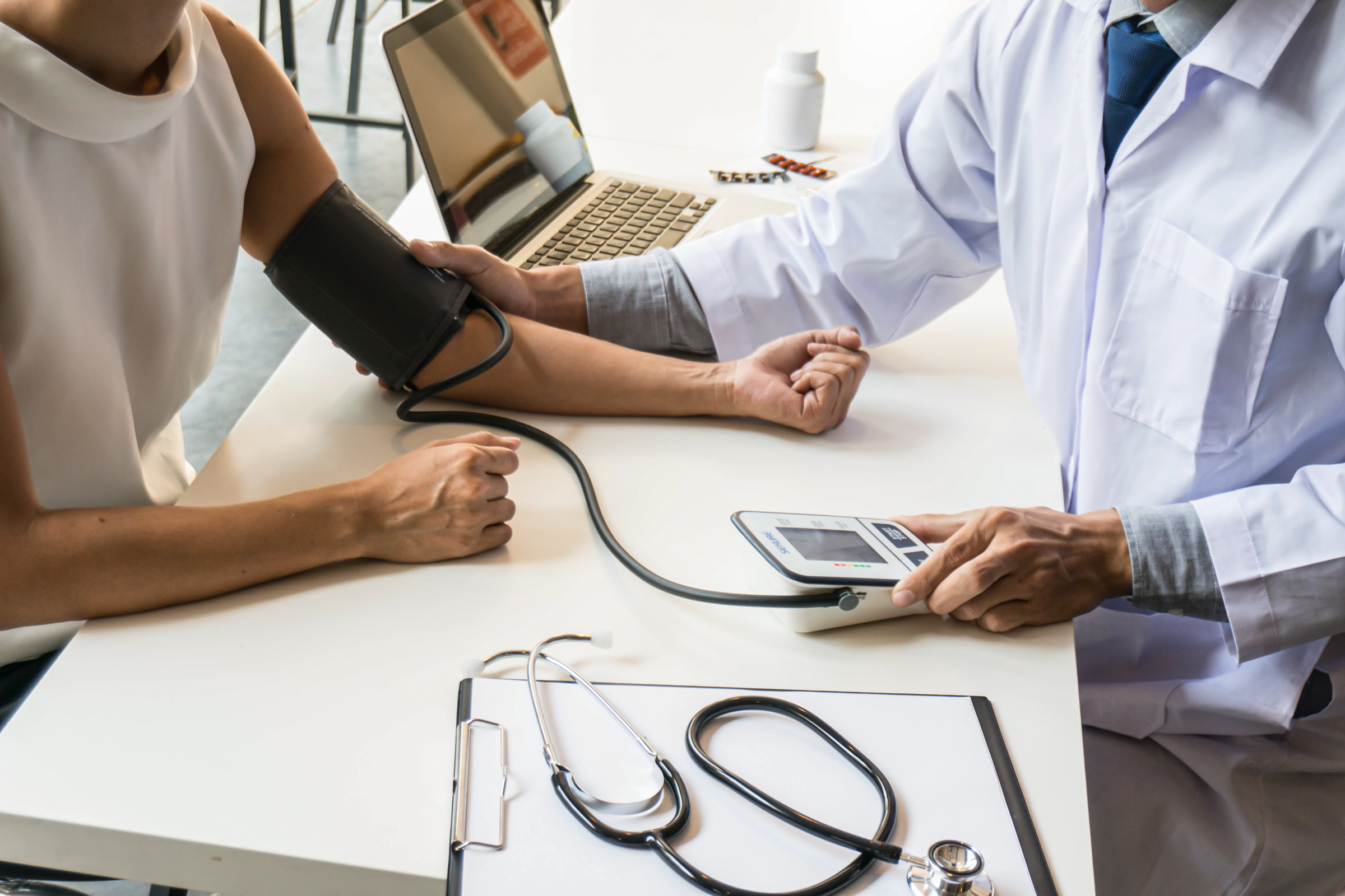 Healthcare professional checking a patient’s blood pressure