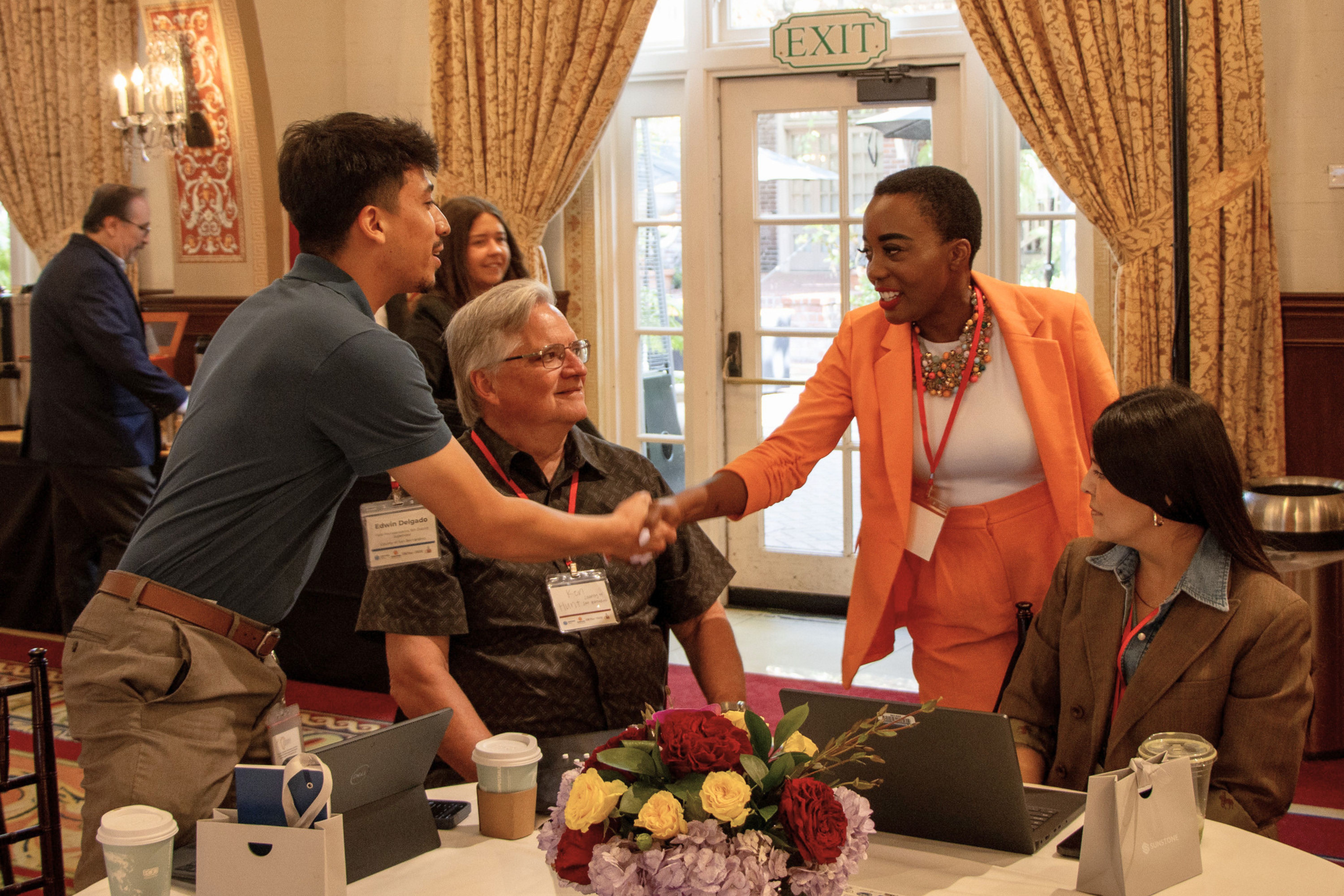 Mentor greeting a participant during a collaborative USC Price event
